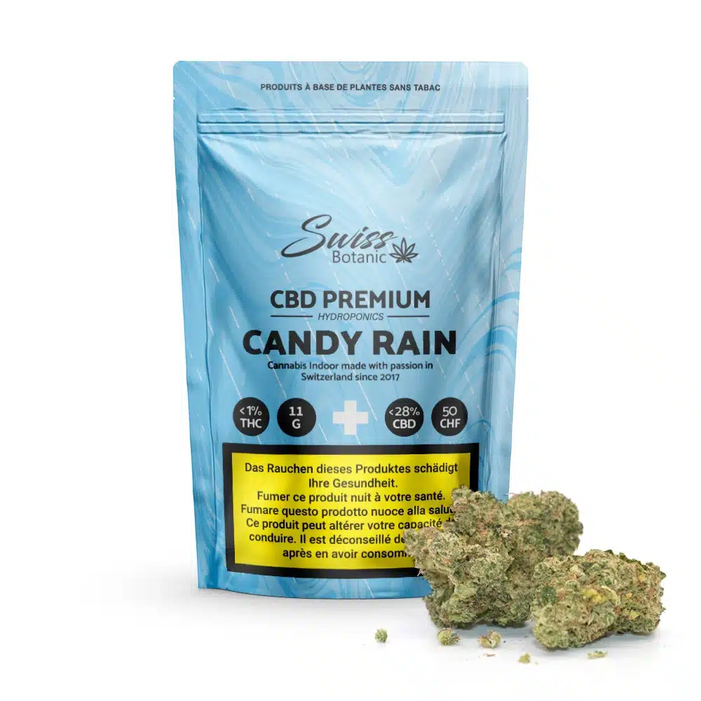 Fleurs de cbd indoor candy rain 1 Fleurs de cbd indoor candy rain comprend un sachet bleu contenant 27 % de cbd, de petites têtes de cannabis vertes et des étiquettes d'avertissement multilingues garantissant clarté et sécurité pour votre expérience premium.